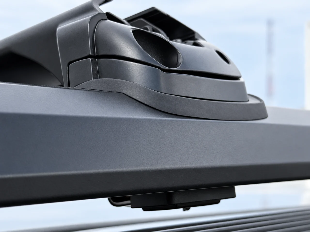 Home 2 12 Retouched photograph of Cobra clamp and rubber contact pad mounted on a raised roof rail